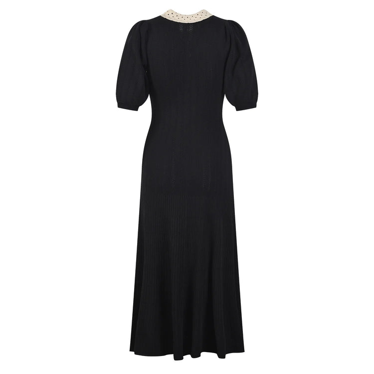 Black dress with a white collar on a white background
