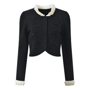 Black jacket with white lace trim on a white background