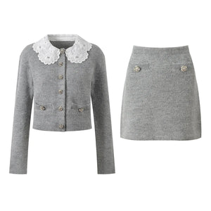 Gray knit jacket and skirt set with decorative buttons on a white background