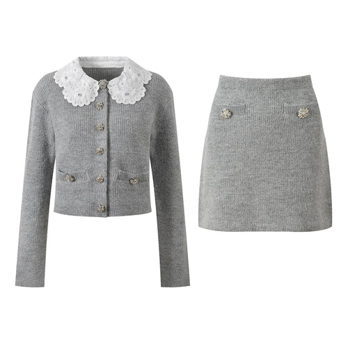 Gray knit jacket and skirt set with decorative buttons on a white background