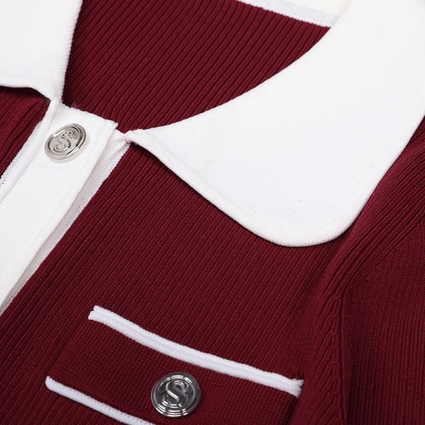 Close-up of a red and white ribbed sweater with buttons.