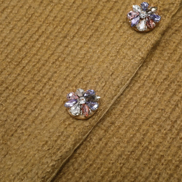 Close-up of decorative buttons on a brown fabric surface