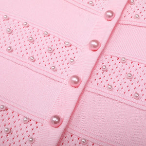 Close-up of a pink garment with pearl embellishments