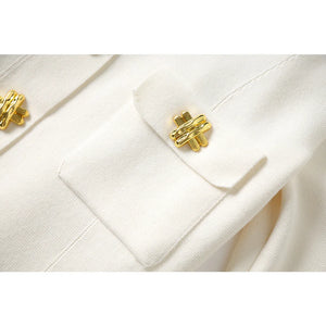 Close-up of a white coat with gold buttons on a white background