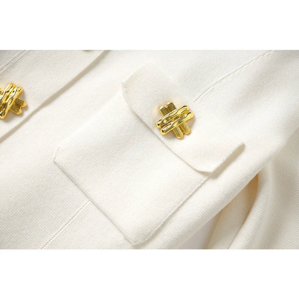 Close-up of a white coat with gold buttons on a white background