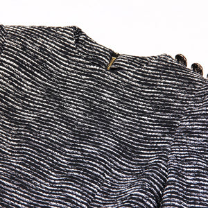 Close-up of a textured black and white fabric with a zipper