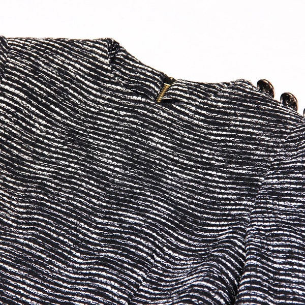 Close-up of a textured black and white fabric with a zipper