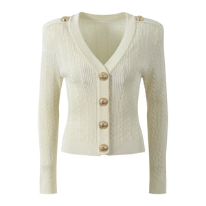 White ribbed cardigan with gold buttons on a white background