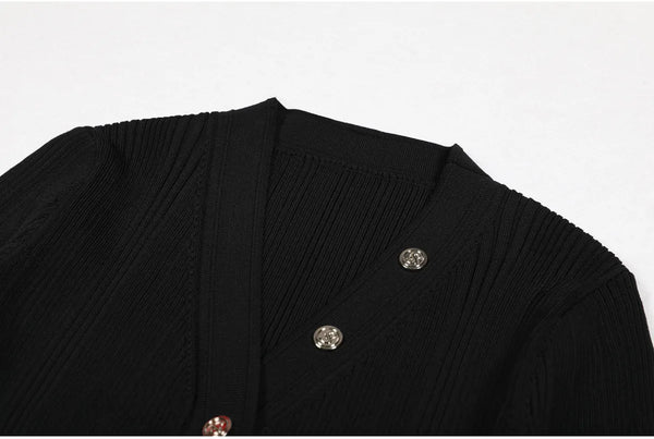 Black garment with decorative buttons on a white background