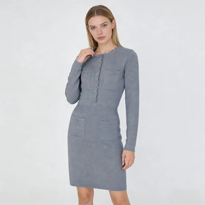 Woman wearing a gray dress with long sleeves on a white background