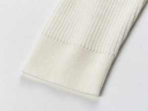 Close-up of a textured white fabric on a light gray background