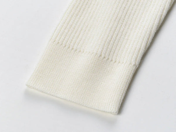 Close-up of a textured white fabric on a light gray background