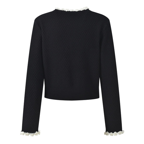 Black textured sweater with white trim on a white background