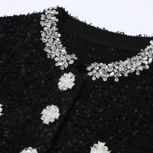 Black fabric with silver floral embellishments on a white background