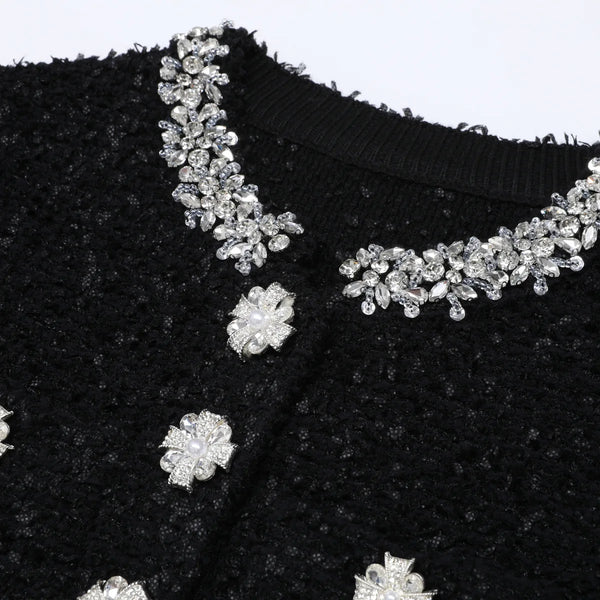 Black fabric with silver floral embellishments on a white background