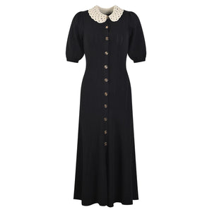 Black dress with a white collar on a white background