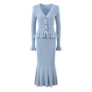 Light blue ribbed knit dress with peplum waist on a white background