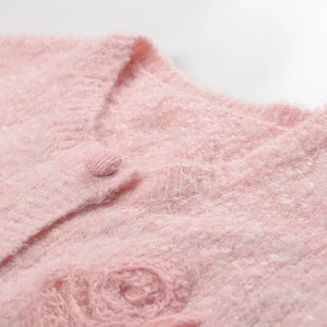 Close-up of a pink textured fabric with a brand logo.