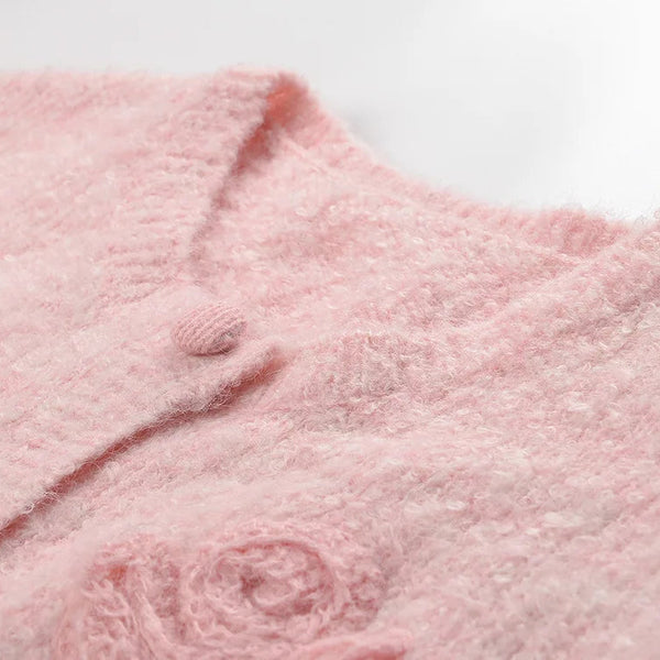 Close-up of a pink textured fabric with a brand logo.