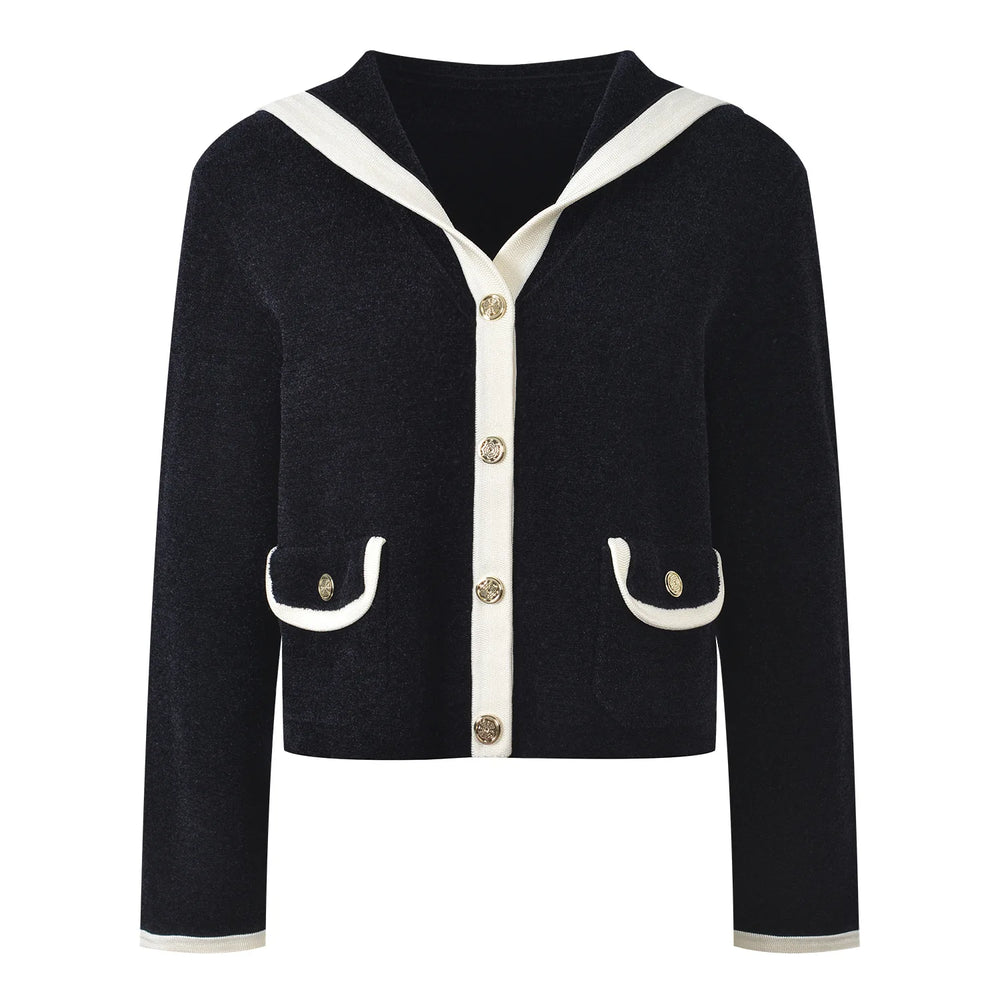 Black cardigan with white trim and buttons on a white background