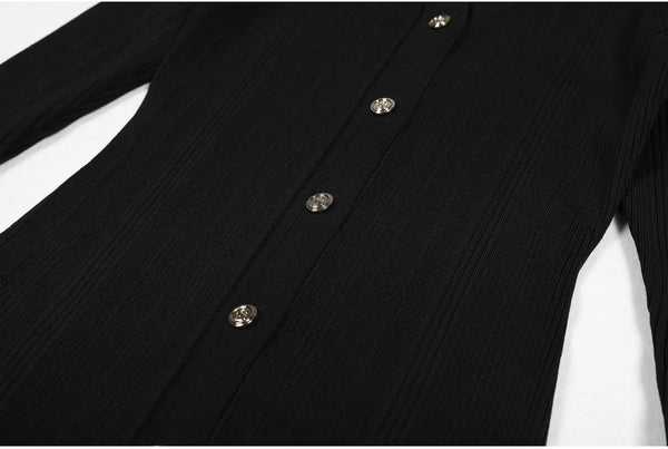 Close-up of a black ribbed sweater with buttons on a white background