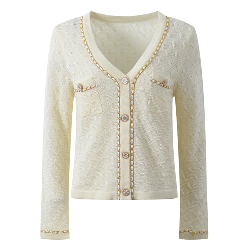 Cream-colored cardigan with button details on a white background