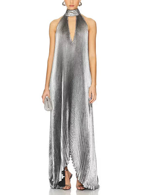 Woman wearing a silver pleated halter neck dress on a white background