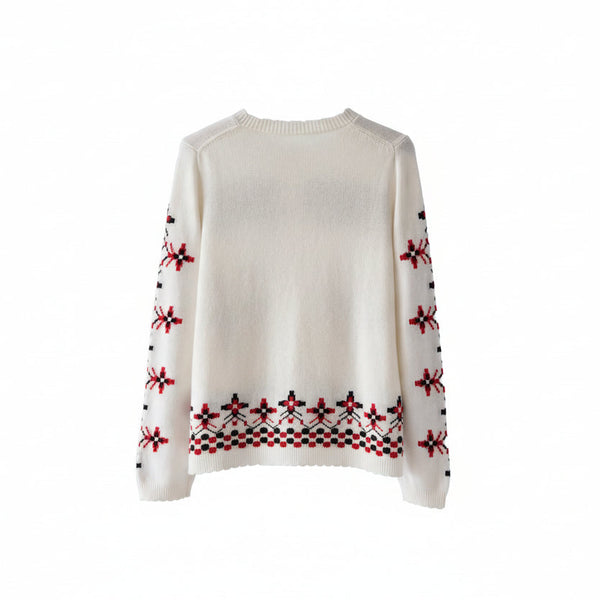 White sweater with red and black pattern on a wooden hanger against a white background