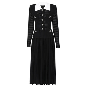 Black dress with white collar and embellishments on a white background