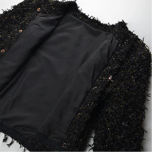 Black fabric on a textured black and gold surface