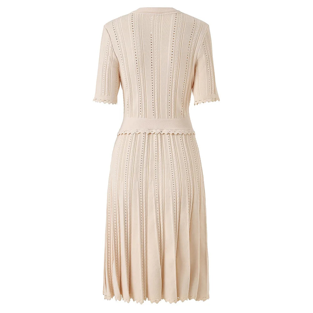 Beige knit dress with button details on a white background