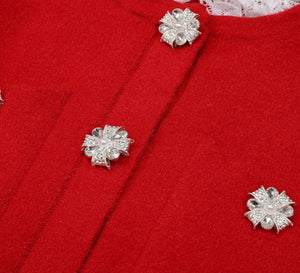 Silver floral earrings on a red fabric background