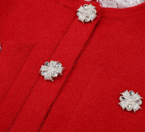 Silver floral earrings on a red fabric background