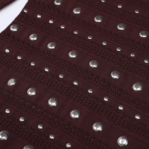 Close-up of a dark red fabric with silver studs
