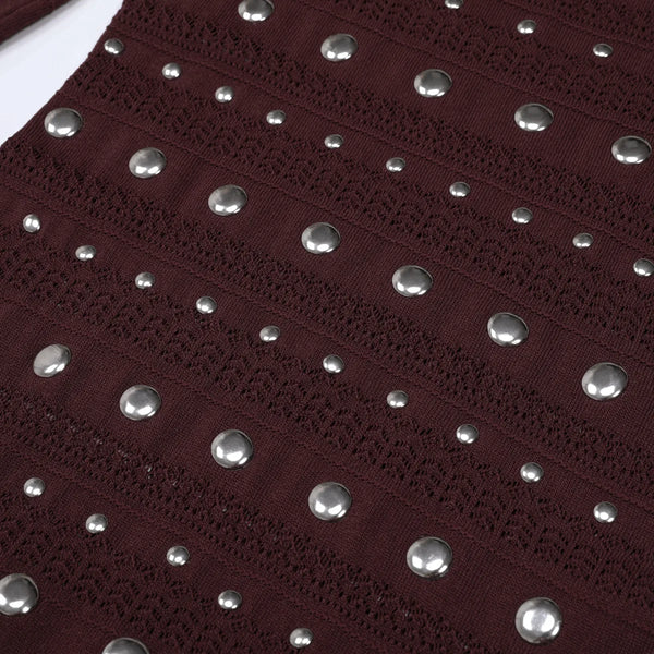 Close-up of a dark red fabric with silver studs