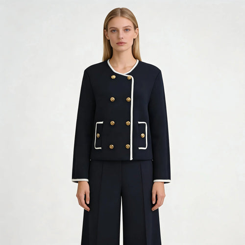 Woman wearing a navy blue suit with gold buttons on a white background