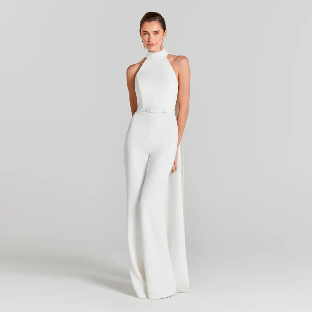 Woman wearing a white jumpsuit on a plain background