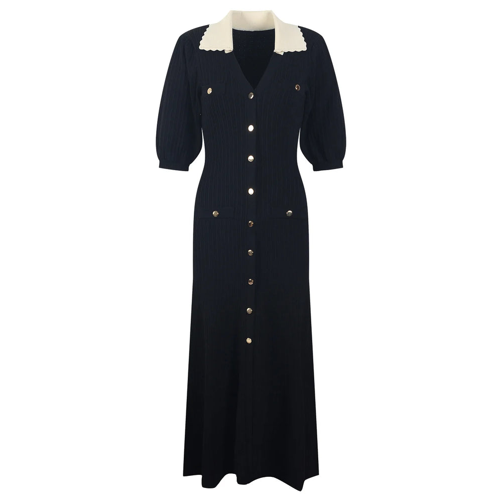 Black dress with white collar and buttons on a white background