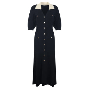 Black dress with white collar and buttons on a white background