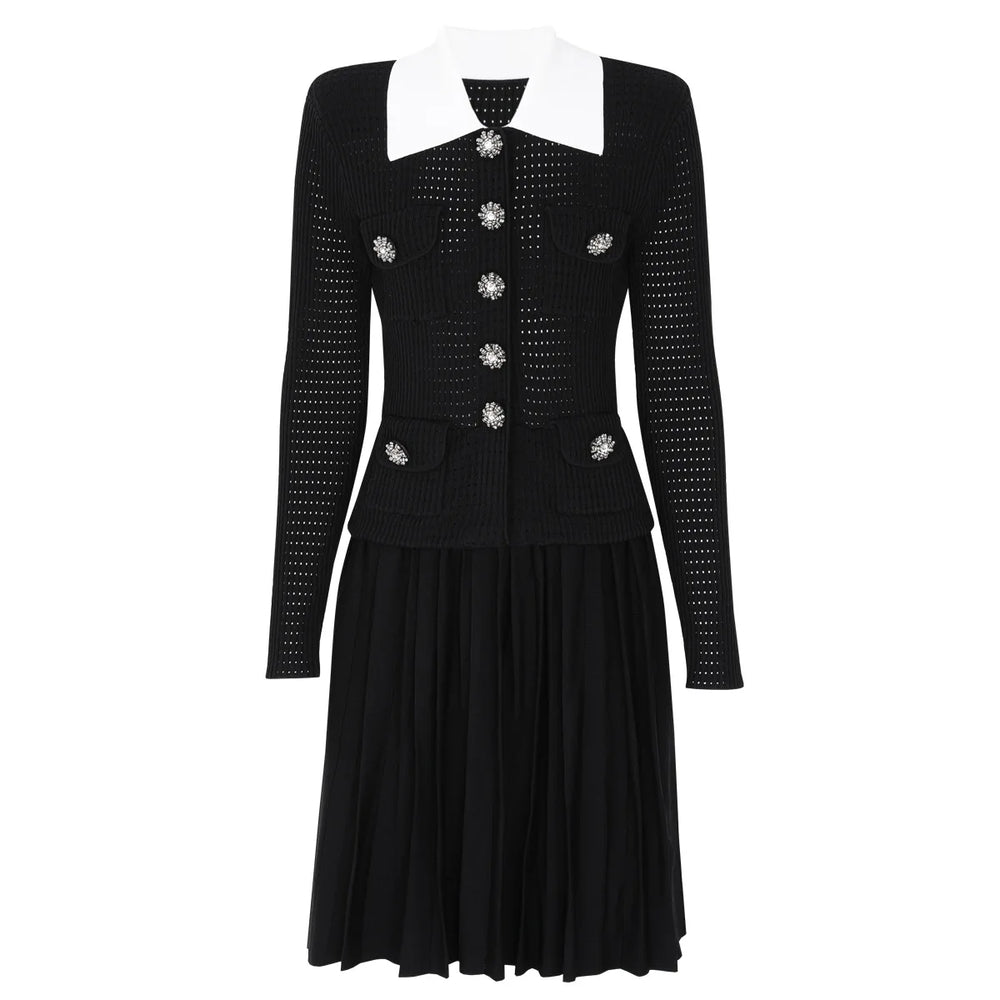 Black dress with white collar and decorative buttons on a white background