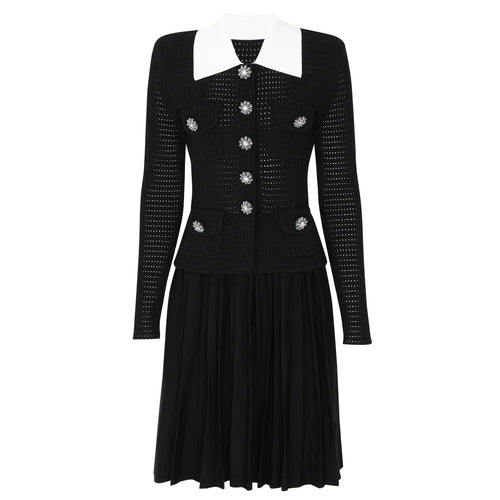 Black dress with white collar and decorative buttons on a white background