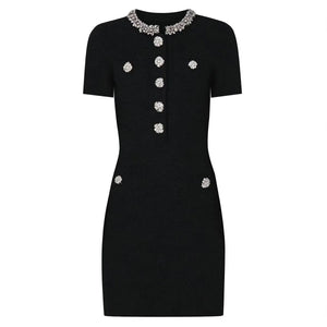 Black dress with decorative buttons and collar on a white background