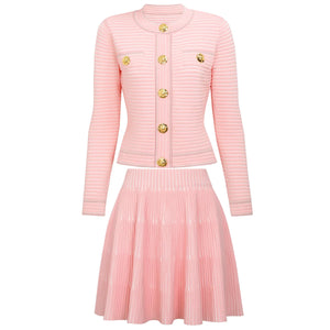 Pink ribbed cardigan and pleated skirt set on a white background