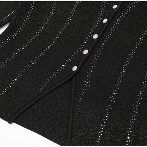 Black fabric with silver glittery thread and buttons on a white background
