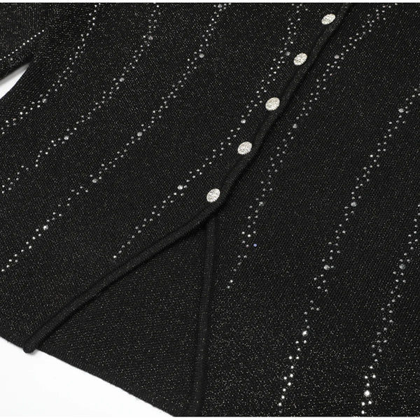 Black fabric with silver glittery thread and buttons on a white background