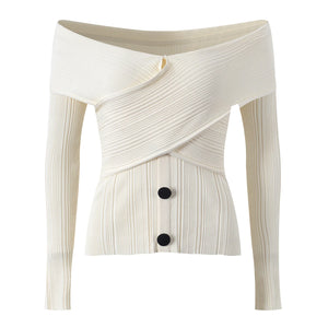 White ribbed knit cardigan with a button detail on a white background