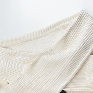 Close-up of textured white fabric on a light gray background