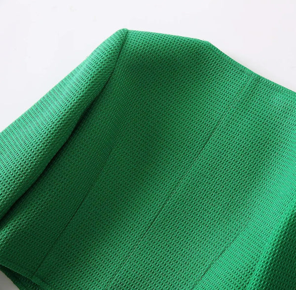 Green knitted fabric on a white background