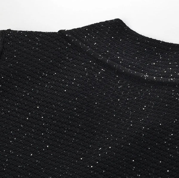 Close-up of black fabric with a textured pattern on a white background