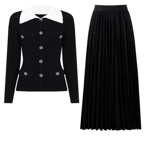 Black jacket with white collar and black pleated skirt on a white background